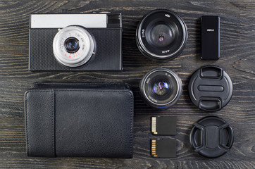 Old camera and lens on a dark wooden background