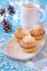 Muffins, mug of tea and illuminated garland