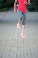 Young Woman Stretching Her Legs and preparing for a marathon