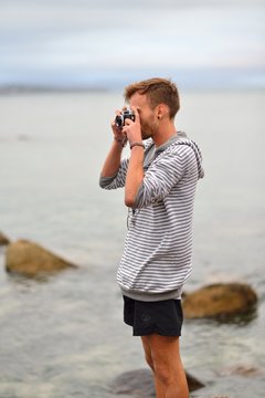 Young guy with old-fashioned camera