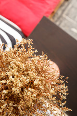 Coffee shop with dry flowers in vase.