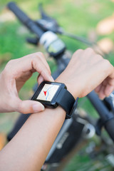 Close-up smart watch on arm women to ride a bicycle