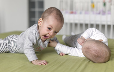 Cheerful twins on the bed