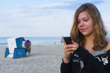 Teenager mit Smartphone im Urlaub