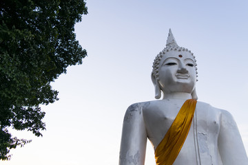 The White buddha status on blue sky background in Thailand