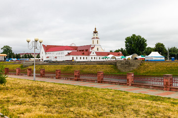 Fototapeta na wymiar Jesuit College. Belarus, Orsha. Built at the church and then restored. View from the promenade. on a cloudy day. Concept of Europe travel, sightseeing and tourism.