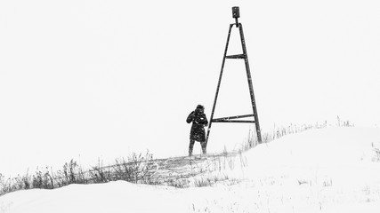 Geodesic triangulation mark. Men on the street in winter. Strong storm, blizzard, cold. Defocused...