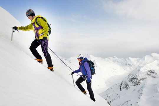 Mountaineers ascending snow-covered mountain, Saas Fee, Switzerland