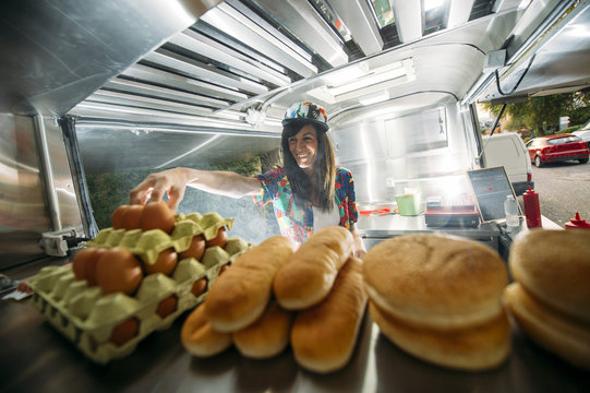 Female in colorful van cooking