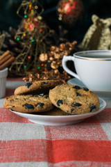 Homemade cookies in a plate on the feast of the new year, christmas. Tasty cookies on a table with a Christmas tree in the background. Tea.