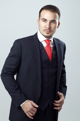 Portrait of handsome man in a studio on a gray background. Studio shot.