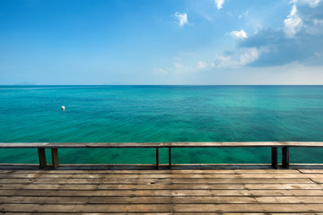 Old wooden deck with blue sea