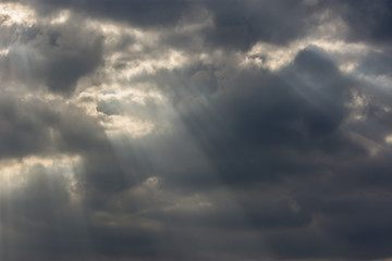 dramatic pre-sunset sky with sunbeams through clouds