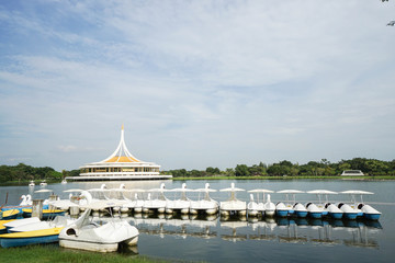 watercycle in the park with pavilion and blue sky backdrop