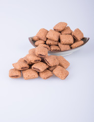cookie or biscuits filled with chocolate cream on a background.