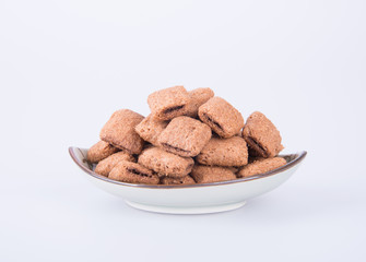 cookie or biscuits filled with chocolate cream on a background.