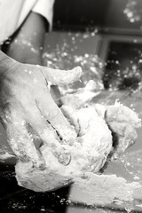 Making dough by female hands on glass table background