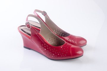 shoe or female red shoes on background.