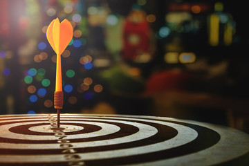 target dart with arrow over blurred Christmas background
