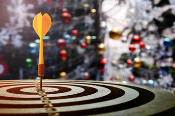target dart with arrow over blurred Christmas background
