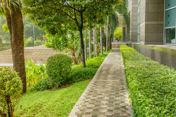 Brick Pathway beside building in the public garden.