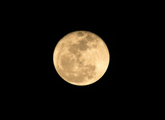 .Full moon over dark black sky on night
