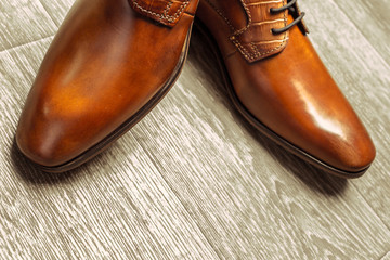 Fashion concept with male shoes on wooden background