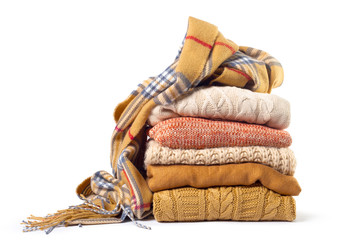 Stack of various sweaters isolated on white background - obrazy, fototapety, plakaty