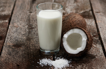 Vegetarian breakfast. Macro shot of coconut and milk on wooden table.