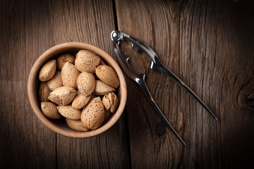 Almonds in-shell in wooden bowl.
