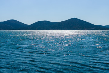 View from the sea on the north coast of Crete, on the west side of the Gulf of Elounda. Crete. Greece.