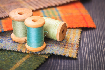Spools of thread and fabric swatches on the table