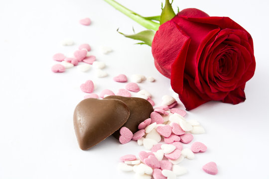 Red rose, chocolate bonbon with heart shape and candies

