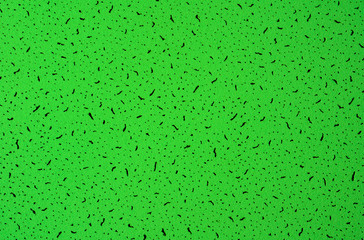 Green abstract grunge paper macro texture with black spots