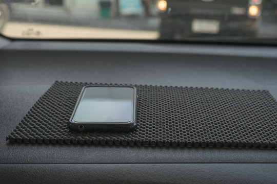 Smart phone, cell phone put on anti slip pad at car console 