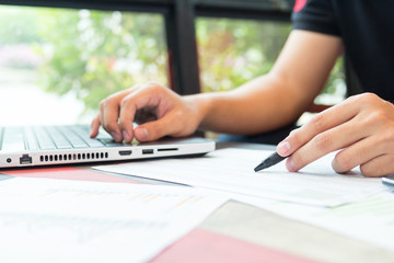 Businessman working by laptop with tablet and smartphone and doc