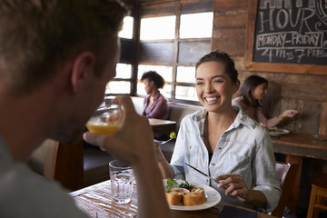 Over shoulder view of couple having lunch in a restaurant