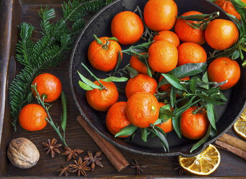 Clementines winter fruits with spices and decorative fir tree br