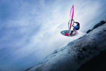 Fototapeta high jump of a windsurfer over a wave obraz