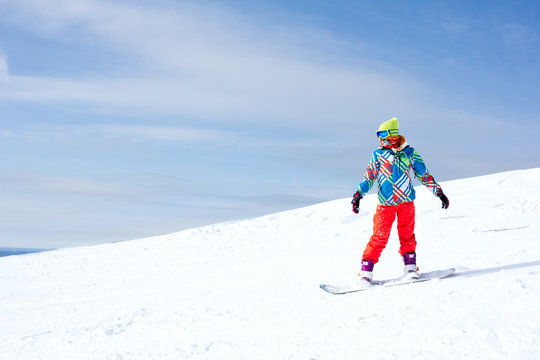 Female snowboarder on the slopes on a sunny morning