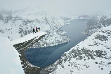 Three boys on famous Troll tongue rock during sever winter in Norway in scandinavia © kovop58