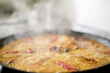 Paella cooking on an electric stove. Typical cuisine of the Valencian Community in Spain