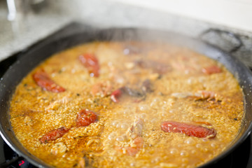 Paella cooking on an electric stove. Typical cuisine of the Valencian Community in Spain