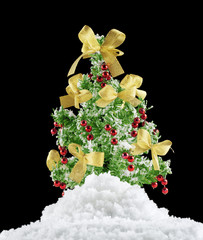 christmas tree on a snowdrift isolated on dark background