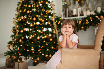 Smiling girl near a Christmas tree