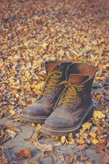 close up of well-worn shoes,boots in forest 