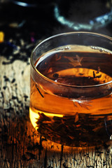 Black tea with flowers cornflower and dried fruit in glass cups