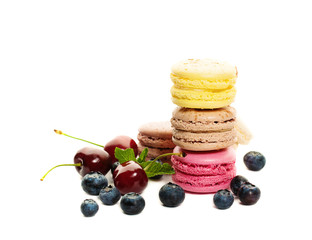 Sweets Macaroons with Blueberries and Cherries on White Backgrou