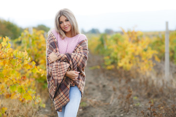 Young beautiful woman with long blonde straight hair and grey eyes,posing outdoors on the...