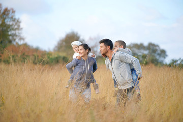 Happy family enjoying fall day in the countryside